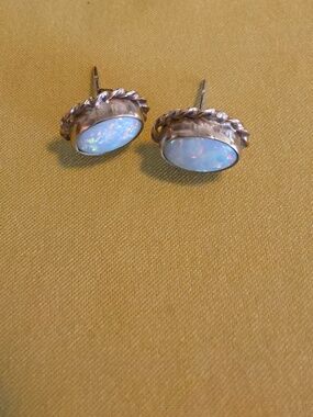Vintage opal stud earrings set in 9 CT gold with a rope or "florette" border.